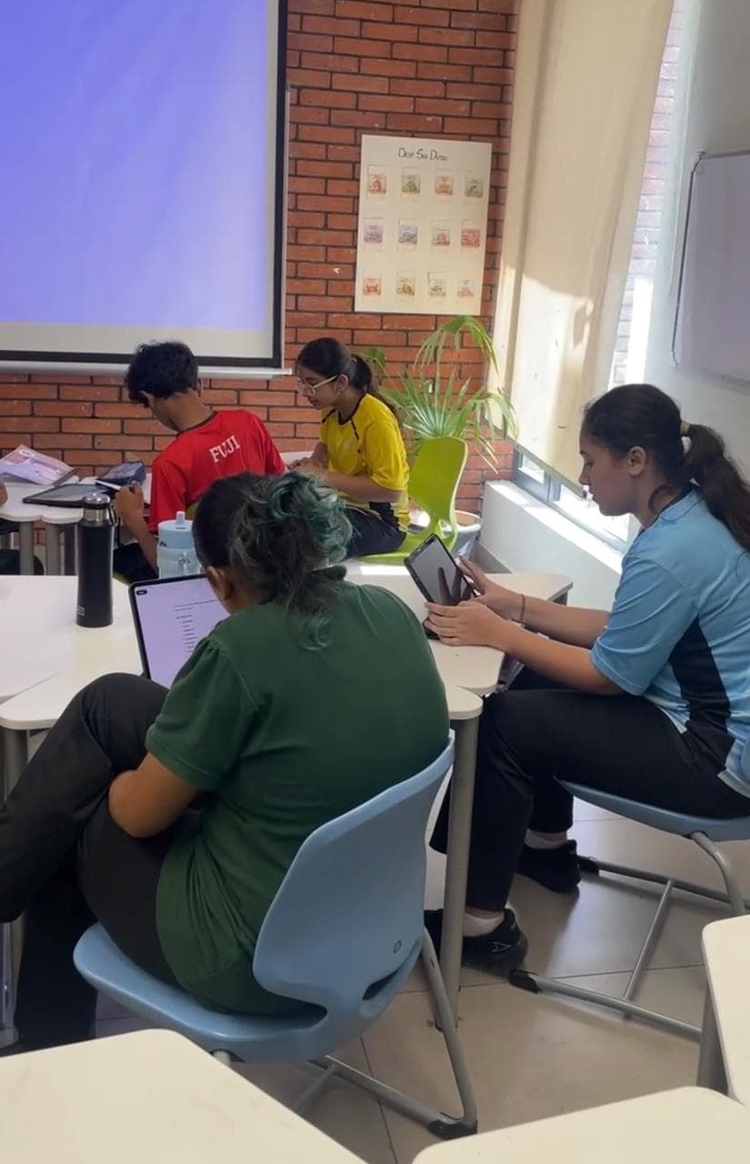Students working through Scholar's Challenge-style practice on tablets
